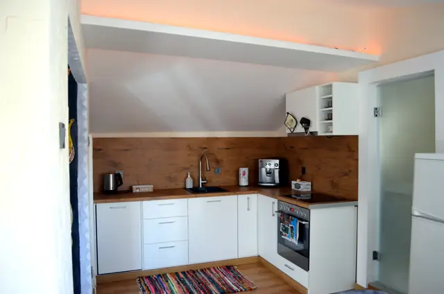 Kitchen under the sloping roof of Artistic Loft